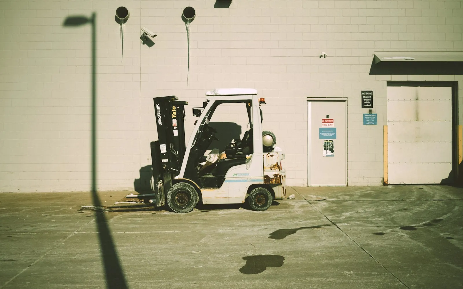 Counterbalance forklift parked outside a building